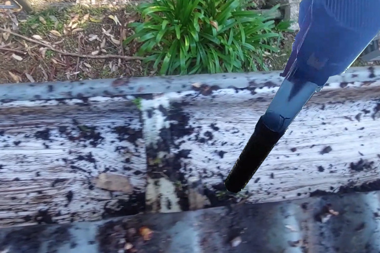 
batemansbay gutter cleaner achieves precision by using a blower to remove small debris from guttering.