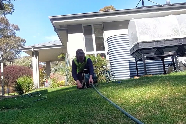 
As the sun sets, the batemansbay downpipe cleaner is coiling his hose after a successful day.